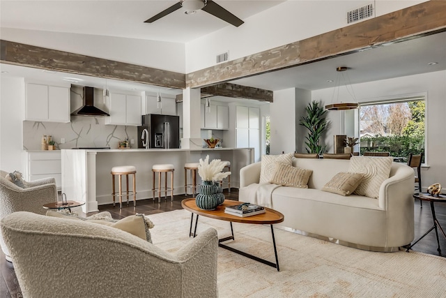 living room featuring lofted ceiling, ceiling fan, and light hardwood / wood-style floors