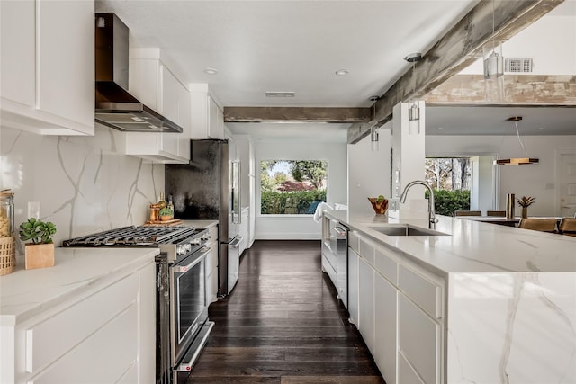 kitchen featuring sink, white cabinetry, wall chimney exhaust hood, light stone countertops, and appliances with stainless steel finishes