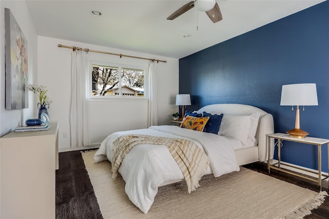 bedroom featuring ceiling fan and dark wood-type flooring