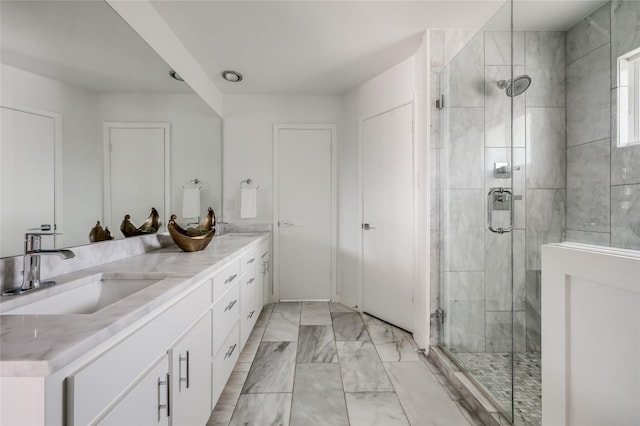 bathroom with a shower with shower door and vanity