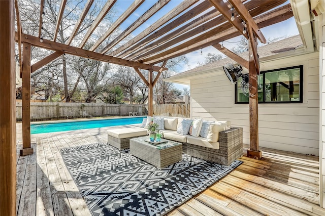 deck with a pergola, an outdoor hangout area, and a fenced in pool