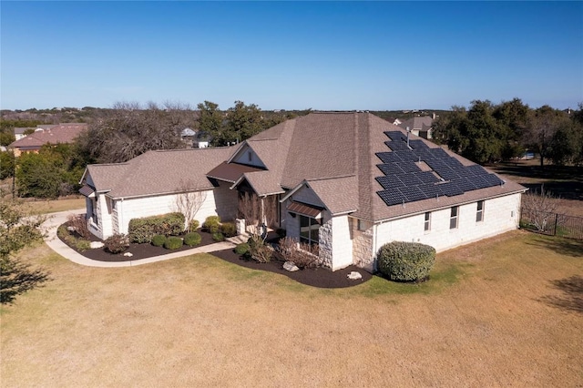 312 Brave Face St, Leander, TX 78641 - view of front of property featuring roof mounted solar panels, roof with shingles, and stone siding