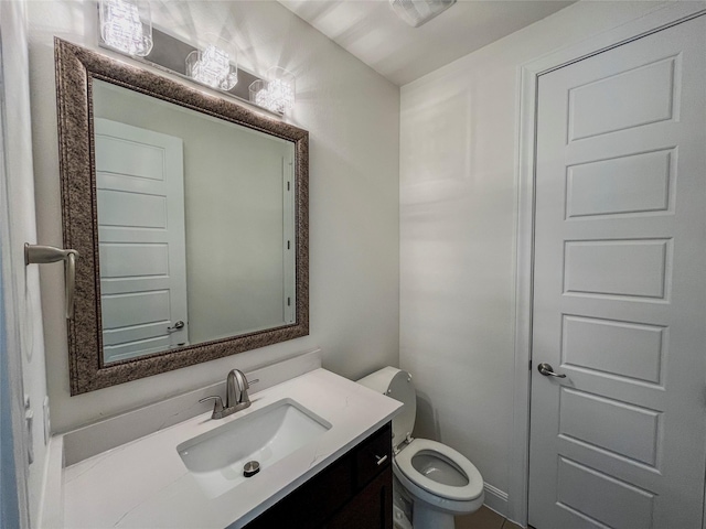 bathroom with toilet and vanity