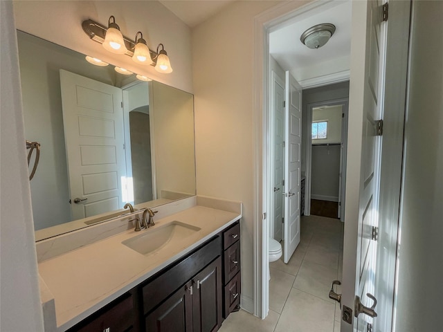 bathroom featuring tile patterned flooring, vanity, and toilet