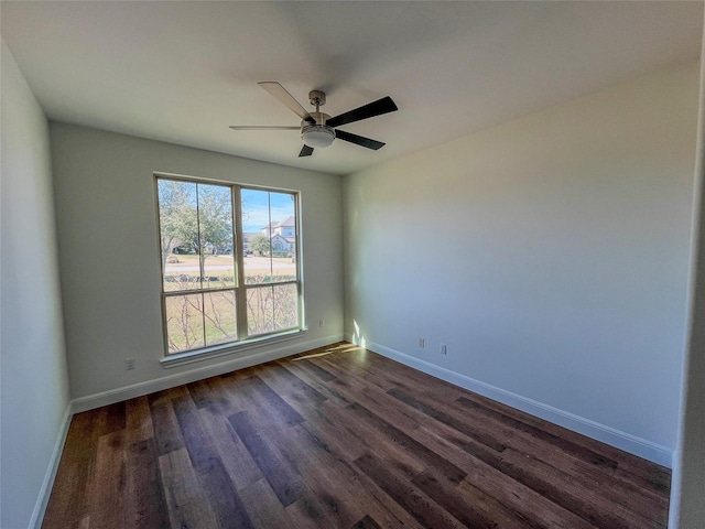 empty room with ceiling fan and dark hardwood / wood-style floors