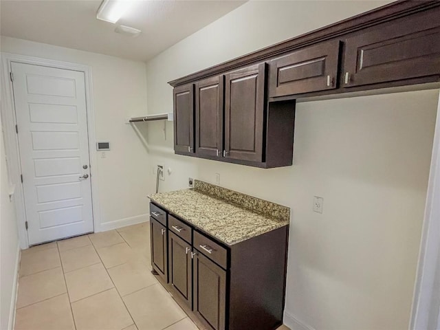312 Brave Face St, Leander, TX 78641 - washroom featuring cabinet space, hookup for a washing machine, light tile patterned floors, and hookup for an electric dryer
