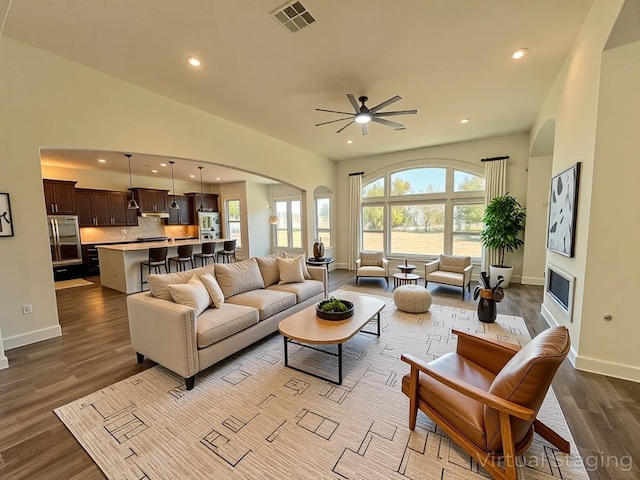 312 Brave Face St, Leander, TX 78641 - living area with a ceiling fan, dark wood-style flooring, arched walkways, and recessed lighting