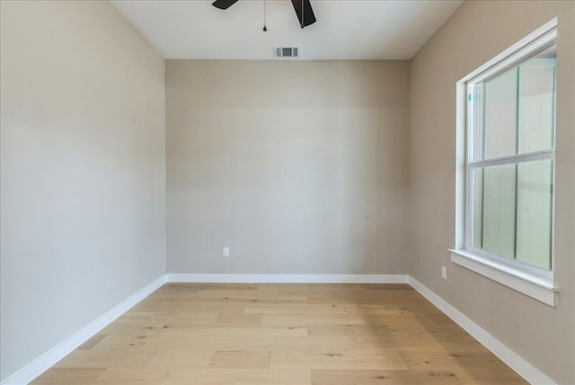 empty room with light hardwood / wood-style flooring and ceiling fan