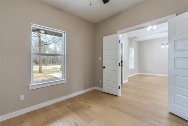 spare room featuring ceiling fan and light wood-type flooring