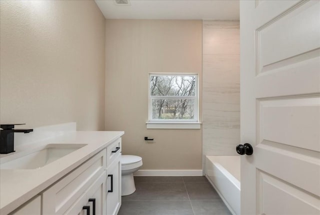 bathroom featuring vanity, a bathtub, tile patterned flooring, and toilet