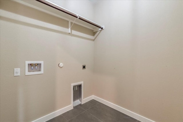 washroom featuring hookup for a washing machine, gas dryer hookup, hookup for an electric dryer, and dark tile patterned flooring