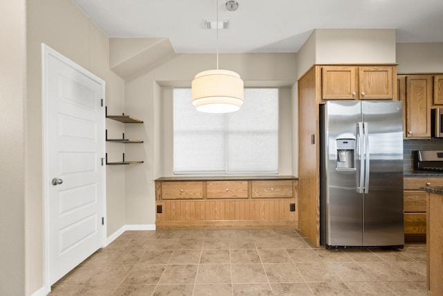 kitchen with decorative backsplash, pendant lighting, and appliances with stainless steel finishes