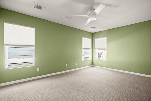 carpeted spare room with ceiling fan