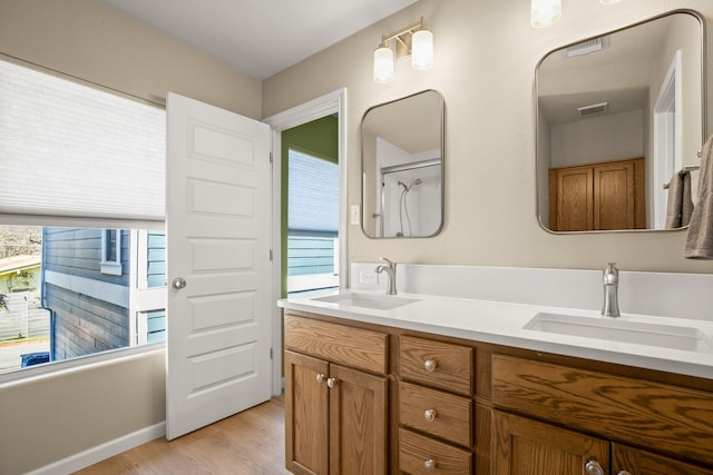 bathroom featuring shower / bathing tub combination, vanity, and hardwood / wood-style floors