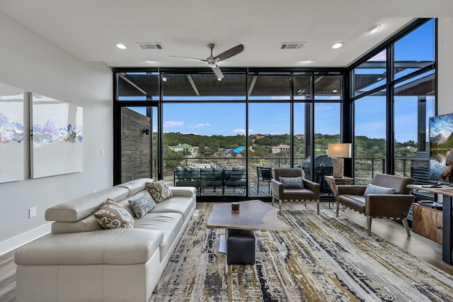 sunroom with ceiling fan and plenty of natural light