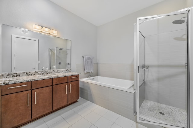 bathroom with tile patterned flooring, shower with separate bathtub, and vanity