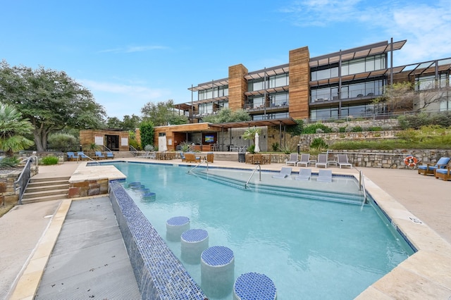 view of swimming pool with a patio