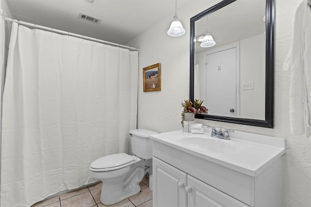 bathroom with toilet, tile patterned floors, and vanity