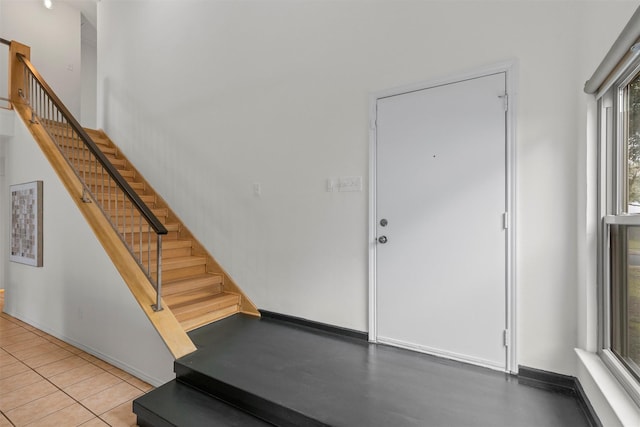 entrance foyer featuring tile patterned floors and a healthy amount of sunlight