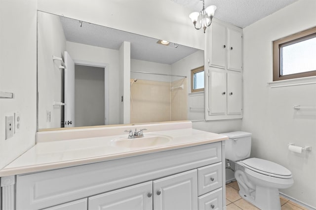 bathroom featuring a textured ceiling, tile patterned flooring, plenty of natural light, and walk in shower