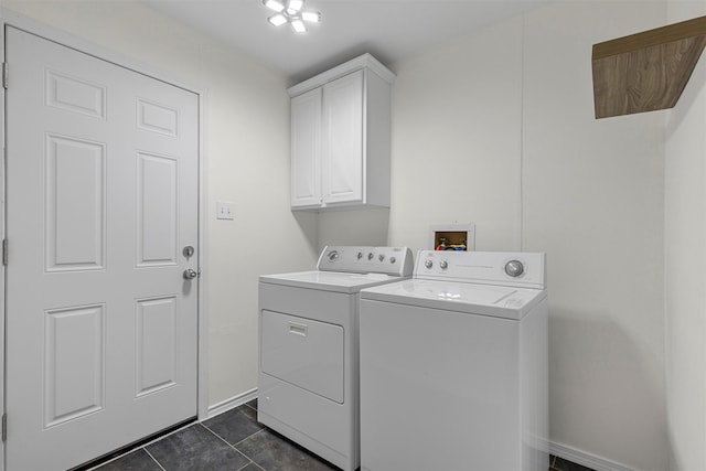 washroom featuring cabinets, dark tile patterned flooring, and independent washer and dryer