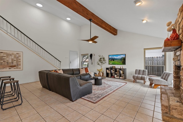 tiled living room with ceiling fan and lofted ceiling with beams