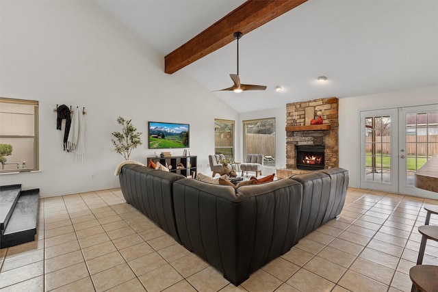 living room with ceiling fan, beam ceiling, a fireplace, and light tile patterned flooring