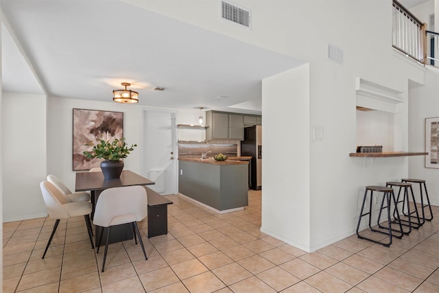 dining area featuring light tile patterned floors and a chandelier