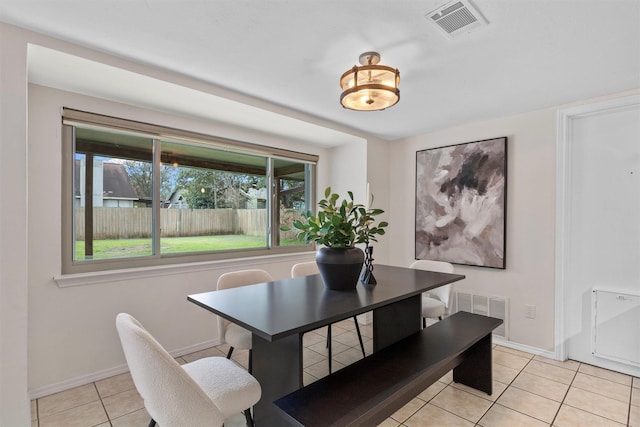 dining space featuring light tile patterned floors