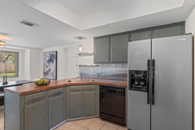 kitchen with black dishwasher, sink, stainless steel fridge with ice dispenser, kitchen peninsula, and light tile patterned flooring