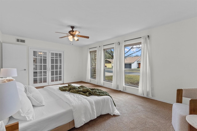 carpeted bedroom featuring ceiling fan and access to exterior