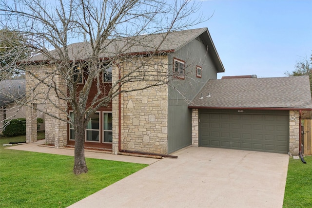 view of front of home with a garage and a front lawn