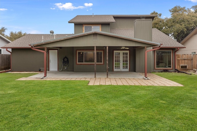 back of property with ceiling fan, french doors, a lawn, and a patio area