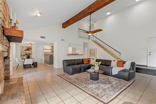 living room with ceiling fan, light tile patterned flooring, beam ceiling, and high vaulted ceiling