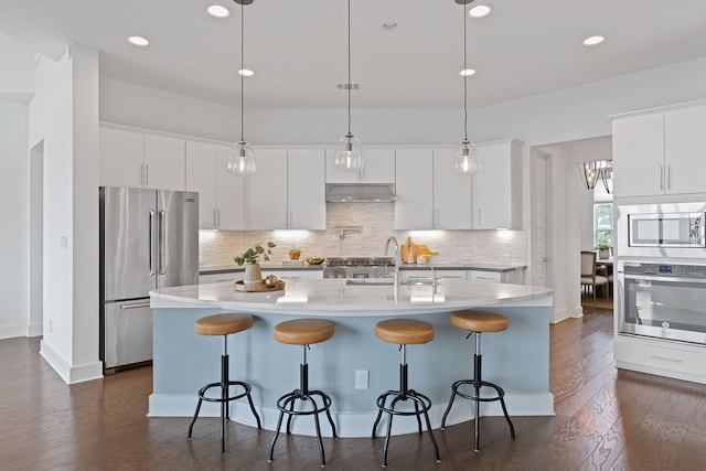 kitchen featuring a kitchen island with sink, appliances with stainless steel finishes, sink, and white cabinets