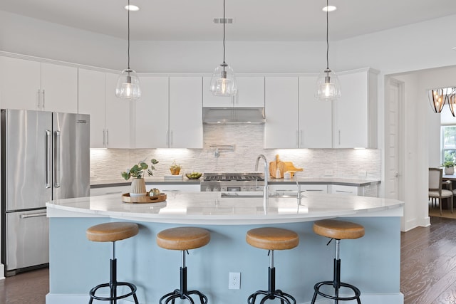 kitchen featuring white cabinetry, high quality fridge, a kitchen island with sink, and dark hardwood / wood-style floors