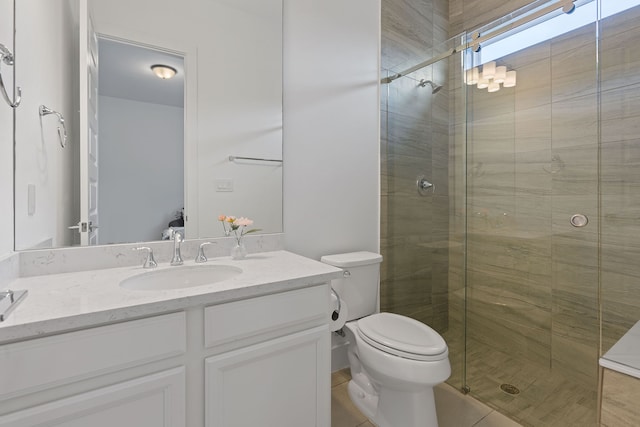 bathroom featuring tile patterned floors, vanity, toilet, and an enclosed shower