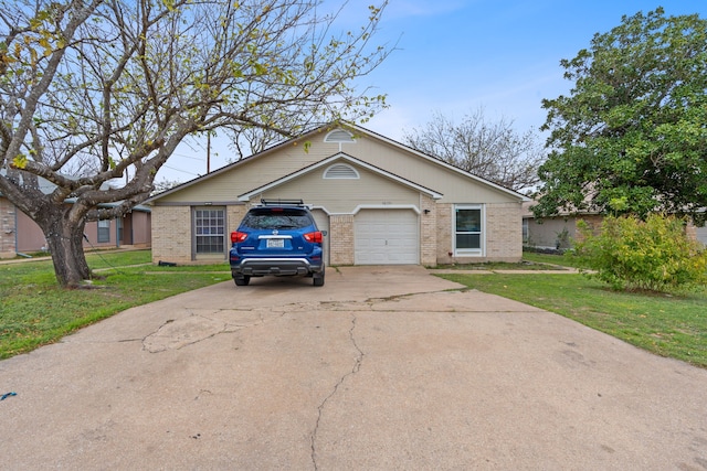 ranch-style house featuring a front yard and a garage