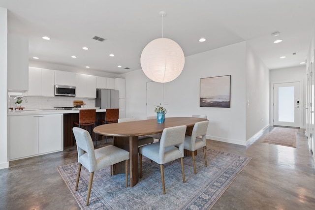 dining space featuring concrete flooring and sink