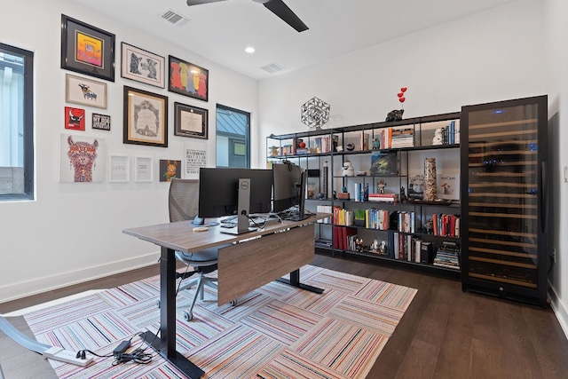 office area featuring ceiling fan, wood finished floors, visible vents, and baseboards