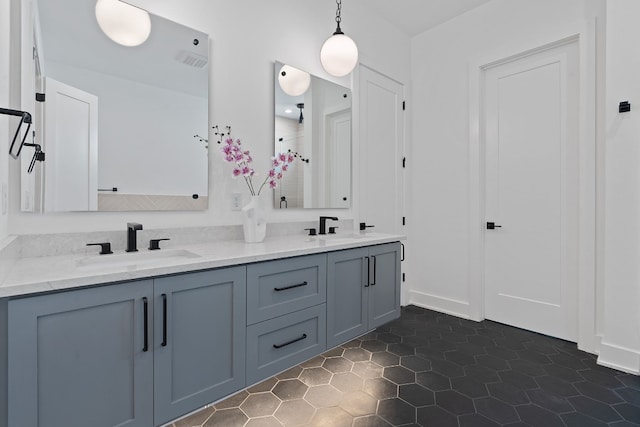 bathroom with double vanity, visible vents, a sink, and tile patterned floors