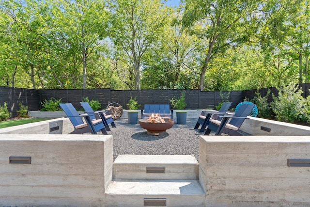 view of patio / terrace with an outdoor fire pit and a fenced backyard