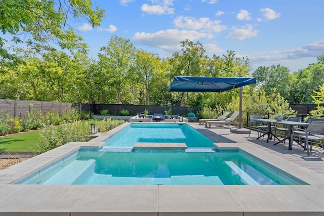 view of swimming pool with a pool with connected hot tub, a fenced backyard, and a patio