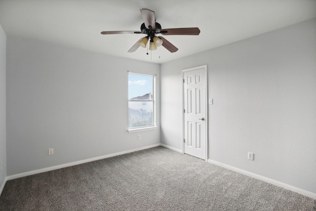 carpeted empty room featuring ceiling fan