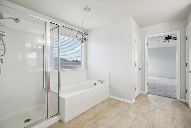 bathroom featuring ceiling fan with notable chandelier and independent shower and bath