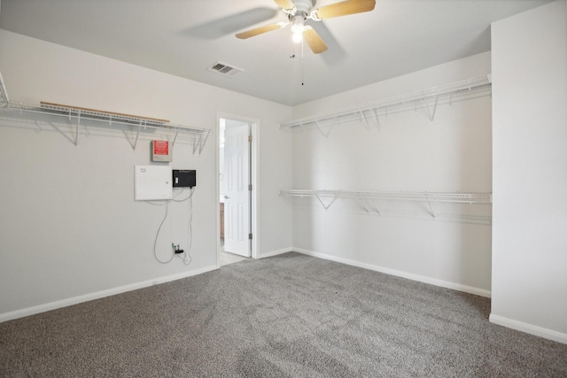 spacious closet with carpet flooring and ceiling fan