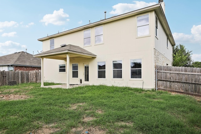 rear view of property with a yard