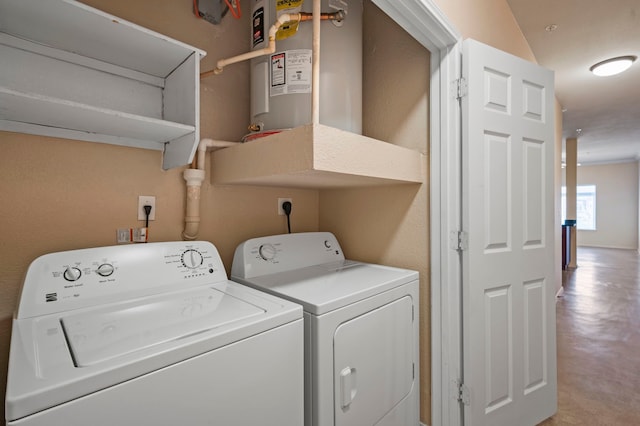 washroom with washer and clothes dryer and water heater