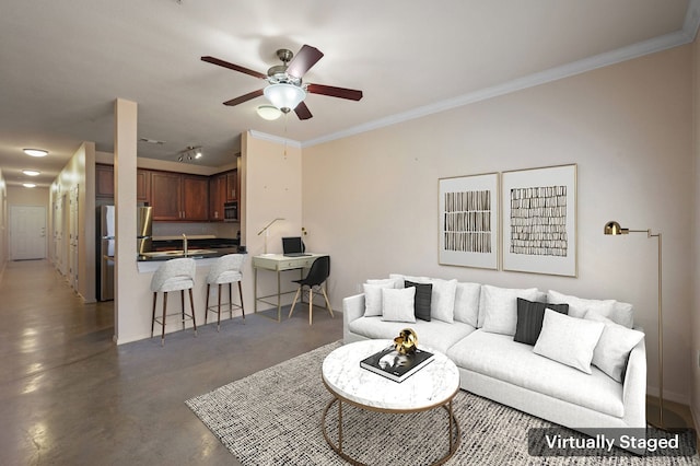 living room featuring ceiling fan, crown molding, and sink