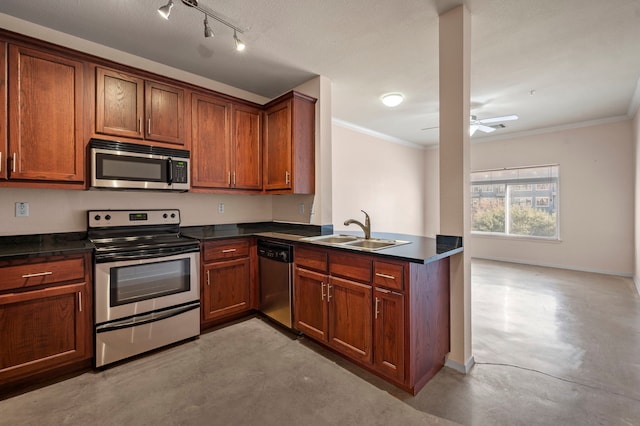 kitchen with appliances with stainless steel finishes, kitchen peninsula, ornamental molding, and sink